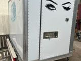 a trailer with a face painted on the side of it
