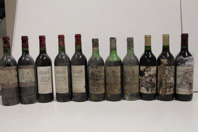 several bottles of wine are lined up in a row on a table