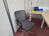 a chair that is sitting in front of a desk