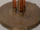 two candles that are sitting on top of a metal stand