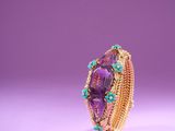 a close up of a ring with amethorate and turquoise stones