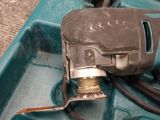 a blue box with a drill and a cord in it