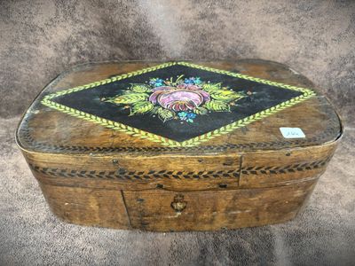 a small wooden box with a floral design on it