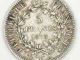 a close up of a coin on a white surface