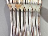 a lot of forks that are sitting on a table