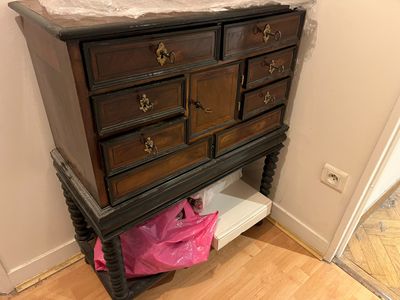 a wooden dresser with a marble top in a room