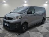 the silver van is parked on a checkered floor in the garage
