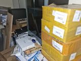 many boxes stacked on top of each other in a room