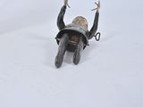 a small statue of a man on a motorcycle in the snow