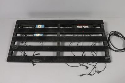 an image of a black metal grille with wires attached to it