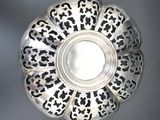 an antique silver plate with black and white designs on it