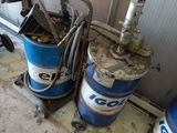 two blue and white barrels sitting next to each other on the floor