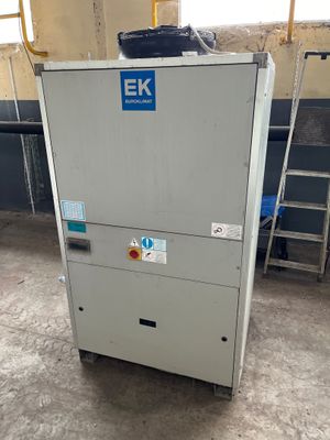 an image of a refrigerator in a room with a ladder in the background
