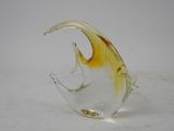 a glass sculpture of a fish on a white surface