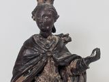 an old statue of a woman with a crown on her head