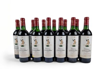 six bottles of red wine lined up in a row on a white surface