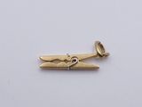 a close up of a gold plated metal object on a white surface