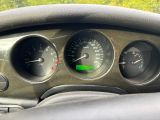 a close up of a dashboard with gauges and a speedometer