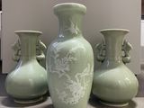 three vases that are sitting on a table