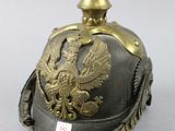 an old helmet with a golden eagle on the top of it