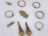 an assortment of gold and diamond rings and pendants