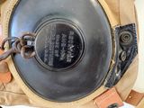 a metal object in the back of a tan bag