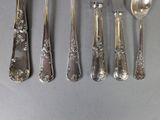 five spoons and two spoons that are on a table