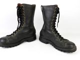 a pair of black combat boots with laces on them