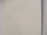 a black cat sitting on top of a piece of paper