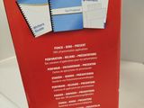 a red box that has a bunch of papers inside of it
