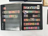 a lot of stamps on a black folder on the table