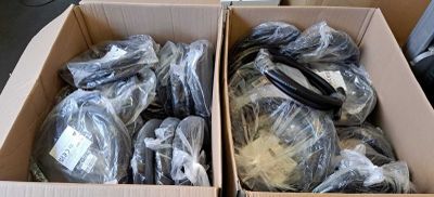 two boxes filled with different types of electronics in them
