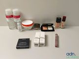 a white table with a lot of cosmetics and other items on it