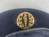a black hat with a gold emblem on it