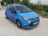 a small blue car parked in a parking lot
