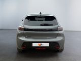 the rear end of a silver car in a white room