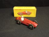a red toy car and a yellow box on a black surface