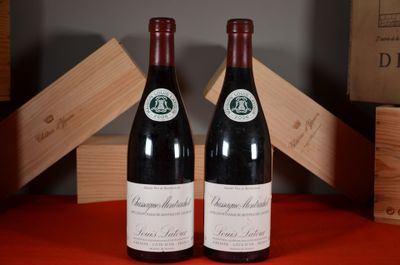 two bottles of wine sitting on a table next to each other