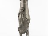 sculpture of a woman holding a vase on a stand on a white surface