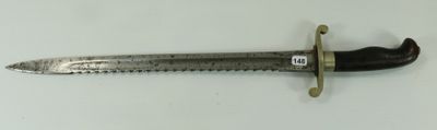 a close up of a knife on a white surface with a ruler