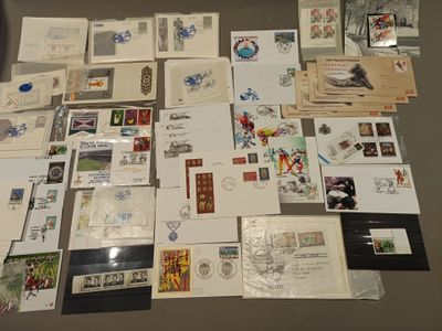 many different types of stamps and postcards laid out on a table