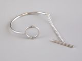 silver bracelet with a bar and a chain on a white surface
