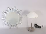 a mirror and a lamp on a table