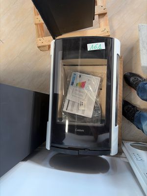 a person standing next to a computer on a desk