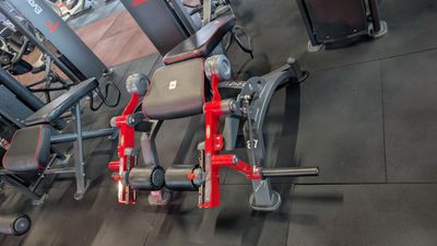 a gym room with a row of exercise equipment