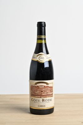the bottle of wine is sitting on the table ready to be eaten
