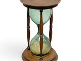 wooden and glass hourglass on stand on white background