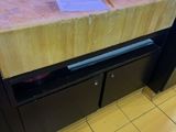 a wooden counter with two papers on top of it