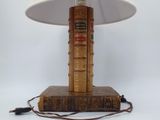 a lamp that is sitting on top of a pile of books