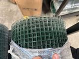 a person holding a piece of wire mesh in their hand
